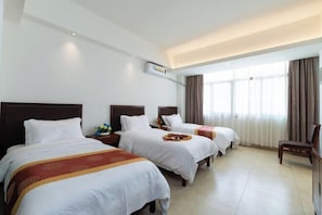 A hotel room with three beds, a large window with curtains, and a ceiling light. - Tongfa Hot Spring Hotel (Wanning)
