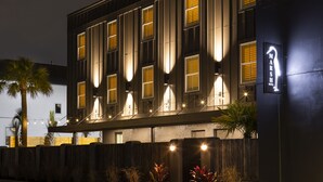 A modern hotel with vertical windows and a sign indicating it is the Marsh Hotel. - Marsh Hotel (New Orleans)