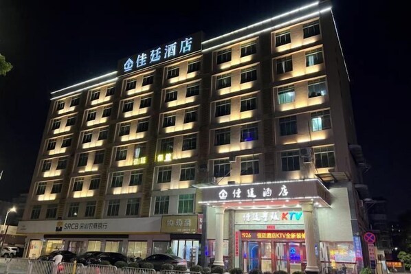A multi-story hotel building with illuminated signage.