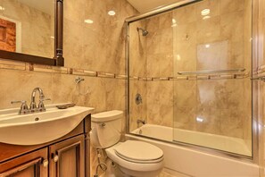 Bathtub, towels, soap, toilet paper