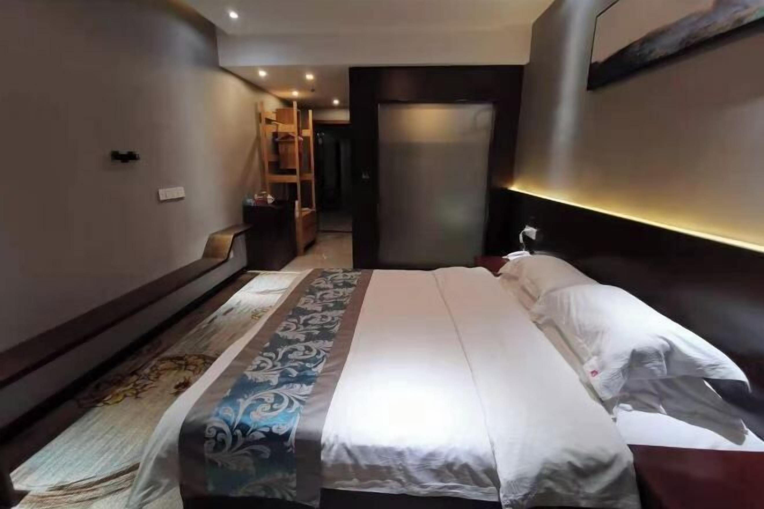 Un dormitorio moderno con una cama grande, cabecera de madera y armario empotrado.