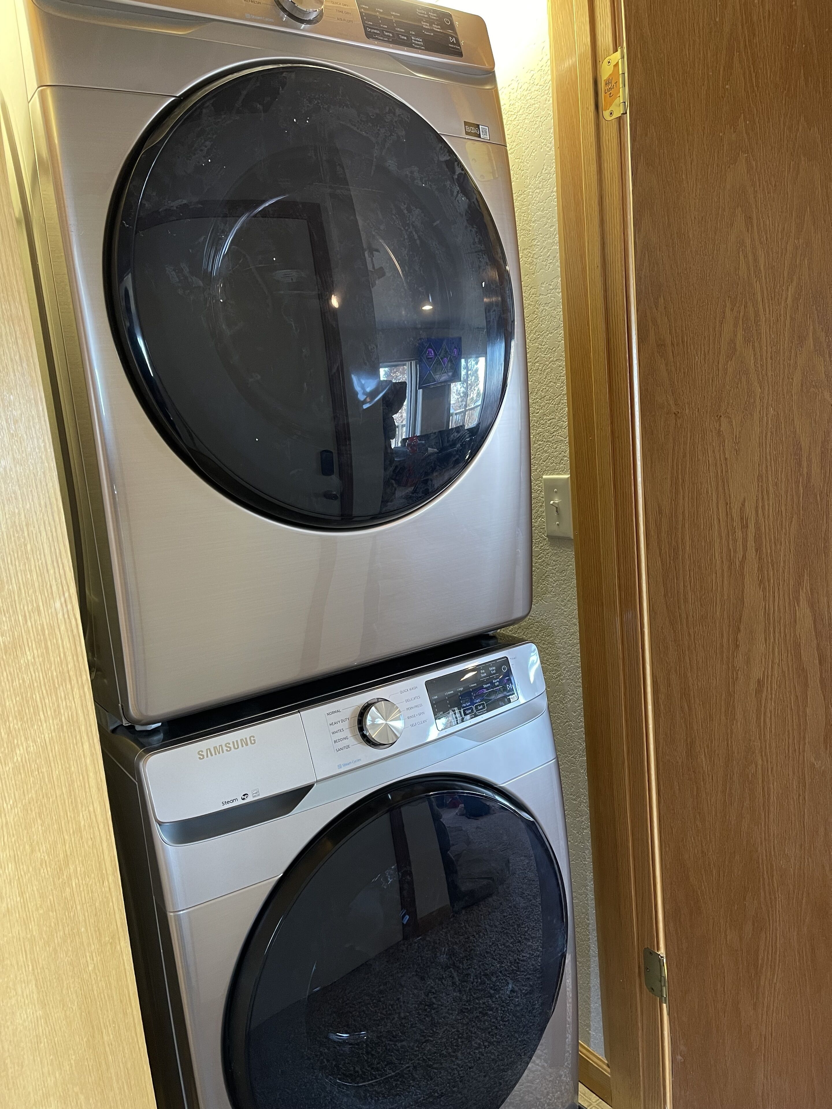 A stacked washer and dryer unit with a Samsung brand label.