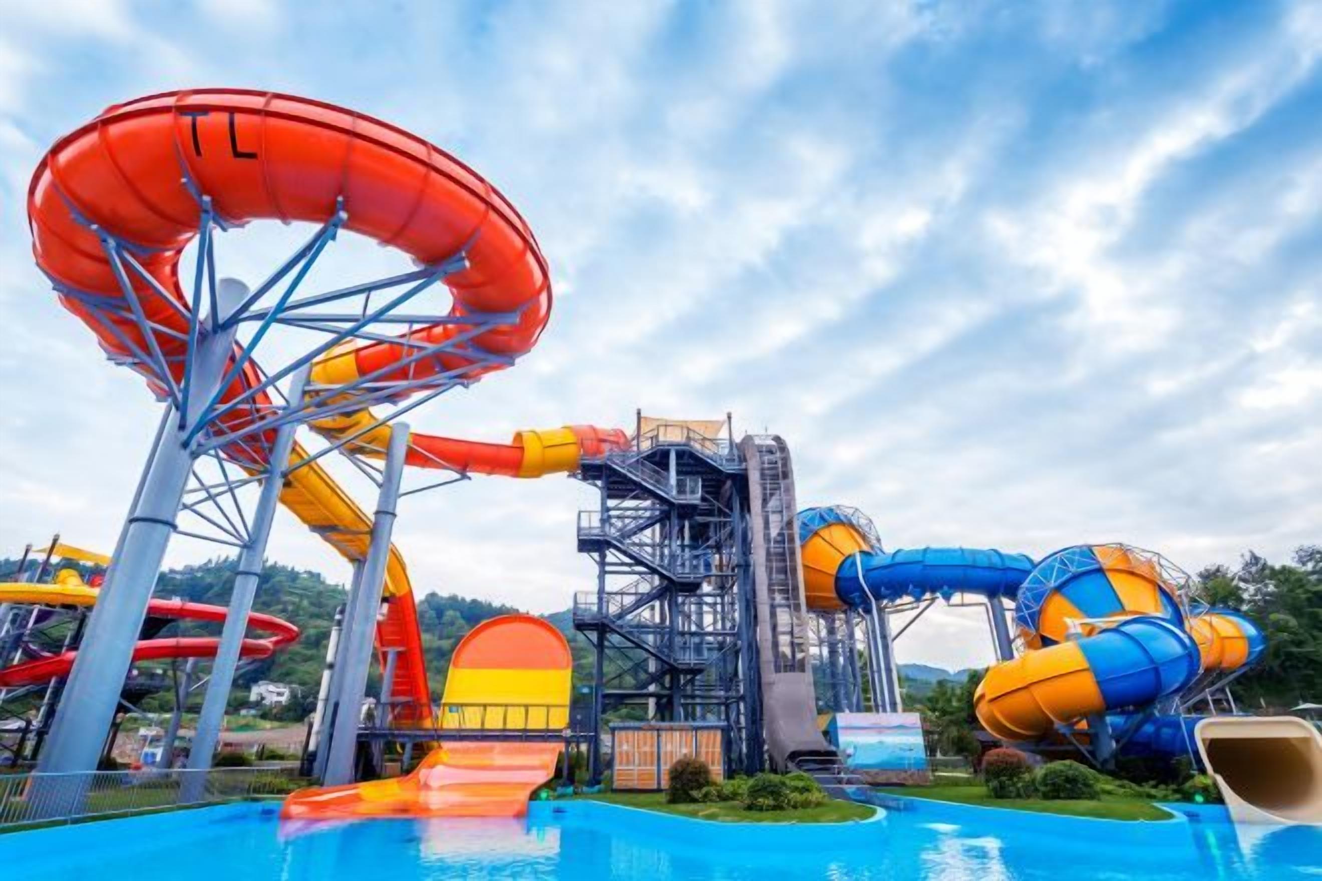 A water park with multiple water slides and a pool.