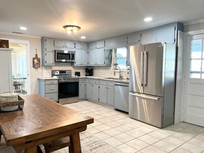 Waterfront home for 12: pets welcome, covered deck, boat slip, beach area, grill