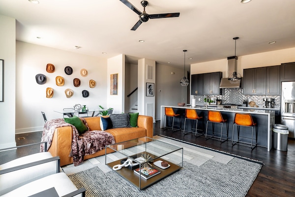 2nd Floor: Bright and open living room featuring a Smart TV,  Designer Furnishings and a dining room that seats 6 guests.