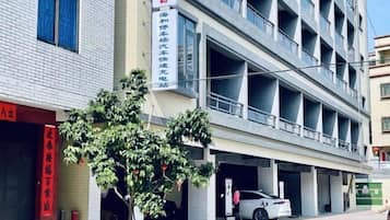 A multi-story building with a parking garage.
