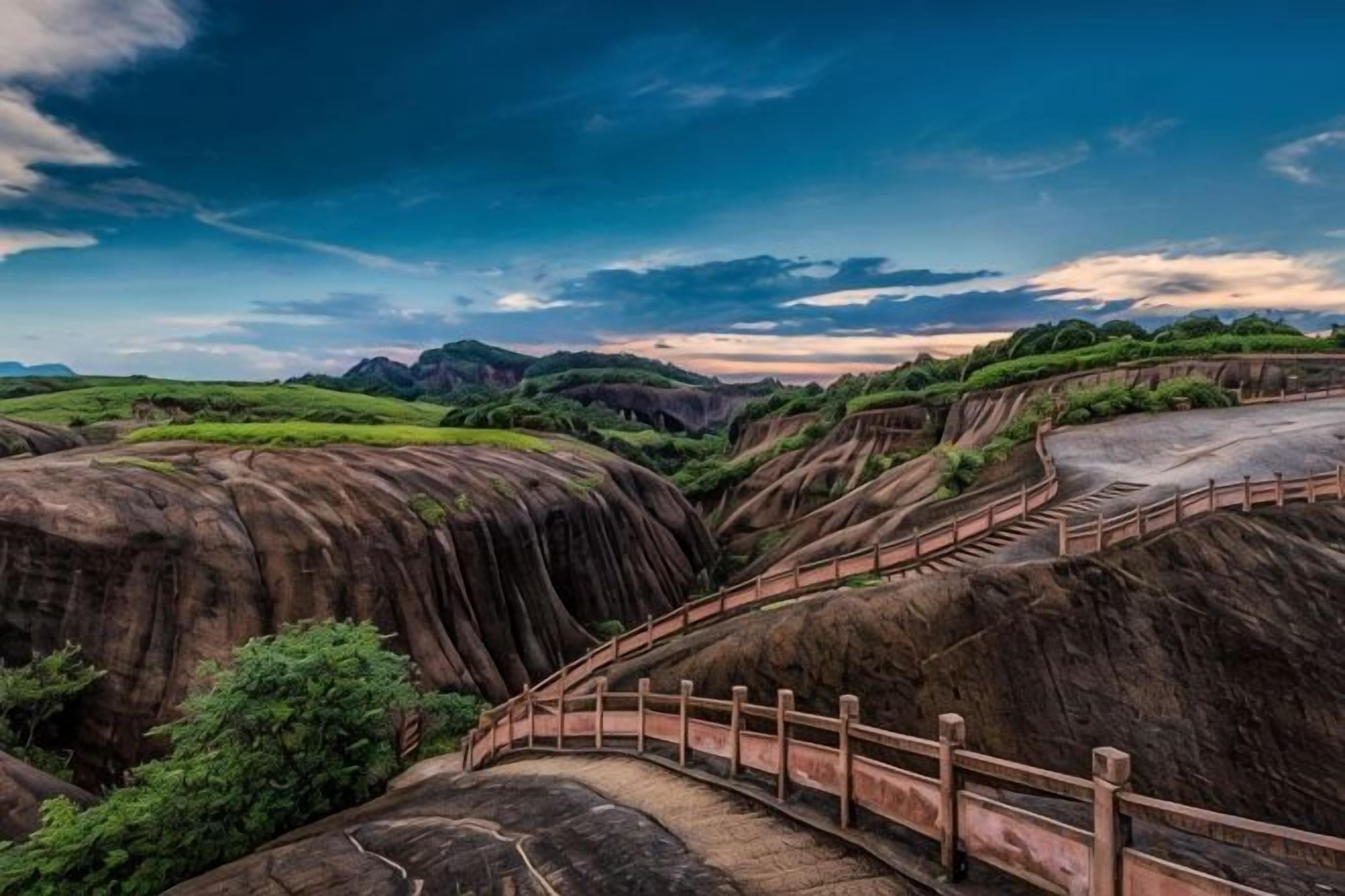 A landscape with terraced hills, a wooden bridge, and a clear sky.