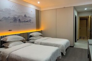A hotel room with two beds, a large wall mural, and a door leading to another room. - ZIxing Wuzhou Hotel (Zixing)