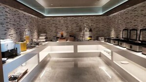A modern kitchen with a brick wall backsplash, stainless steel appliances, and white countertops. - Thank You Intercity Hotel (Junan Leshang Building) (Junan County)