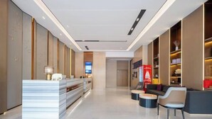 A modern hotel lobby with a reception desk, seating area, and a large digital screen. - Thank You Intercity Hotel (Junan Leshang Building) (Junan County)