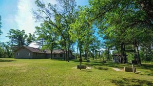 A grassy area with a house and a gazebo.