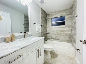 Bathtub, hair dryer, towels, soap