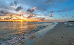 A beach at sunset with calm waves and a clear sky. - 2nd row Ocean Views 4br 3ba Sleeps 12, '26 Pool Amenity Card, linens included (Edisto Island)