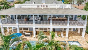 A two-story house with a large balcony, a swimming pool, and outdoor seating areas. - Private Luxury Villa in Kihei. Just moments walk to the beach. 10/10 reviews! (Kihei)