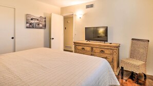 A bedroom with a bed, a dresser, a television, a chair, and a ceiling fan. - 5 Mi to Pima Air & Space Museum: Sunny Tucson Gem (Tucson)