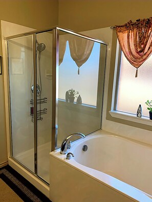 Combined shower/bathtub, towels, soap, toilet paper