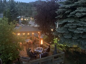 An outdoor patio area with a gazebo, seating, and a wood stove. - Destination Inn (Radium Hot Springs)