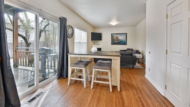 A modern kitchen with a dining area, large windows, and a view of the outdoors. - 230 4th Street (Ashland)