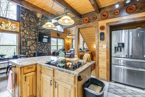 Enjoy cooking in this well-equipped kitchen with a central island, double ovens, and stove.