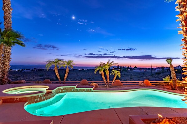 Relax by the serene pool surrounded by palm trees and breathtaking desert views.