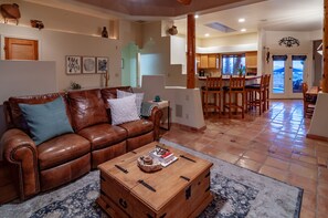 Relax in this inviting living area with a leather sofa, coffee table, and patterned rug.