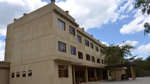 A multi-story building with a flat roof and a covered entrance area. - Chambai Safari Hotel (Naivasha)