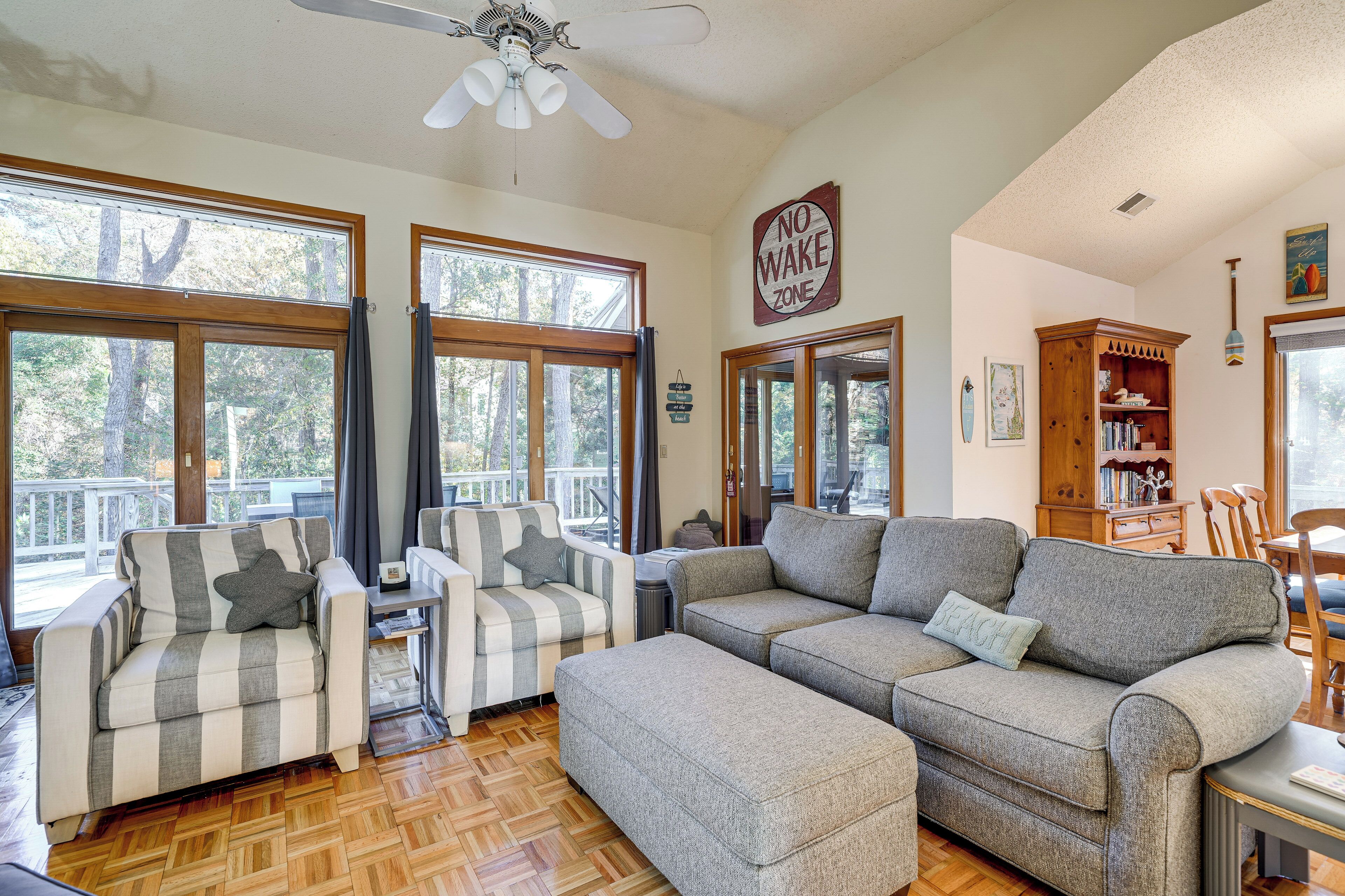 A cozy living room with a sectional sofa, armchairs, and a wooden coffee table.