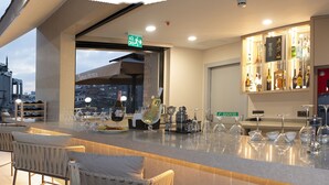 A rooftop bar with outdoor seating, a bar counter, and a view of the cityscape. - Aprilis Deluxe Hotel (Istanbul)