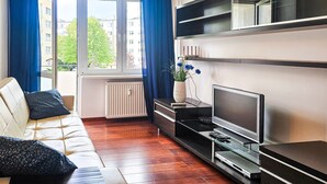 A modern living room with a sofa, TV, and shelves. - Matejki - Ma05 (Swinoujscie)