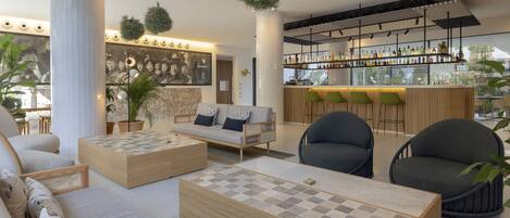 A modern lounge area with a bar, seating arrangements, and a checkered coffee table.