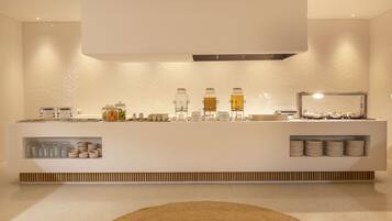 A modern bathroom with a vanity, glass jars of toiletries, and a mirror.
