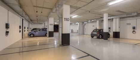 A parking garage with numbered parking spaces, including 110, 108, 113, and 104.