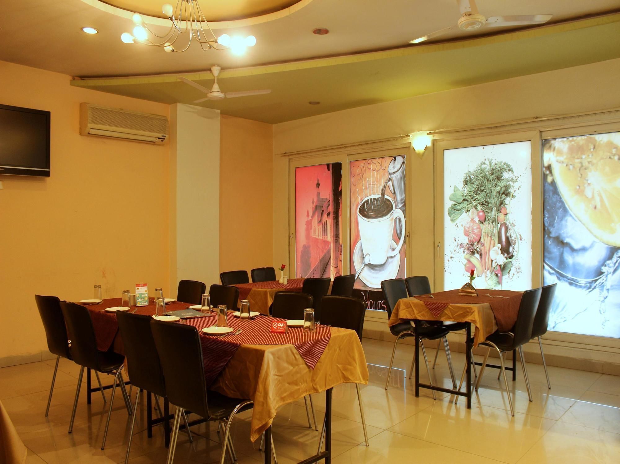 A conference room with tables set for a meeting, a ceiling fan, and a large window with a cityscape view.