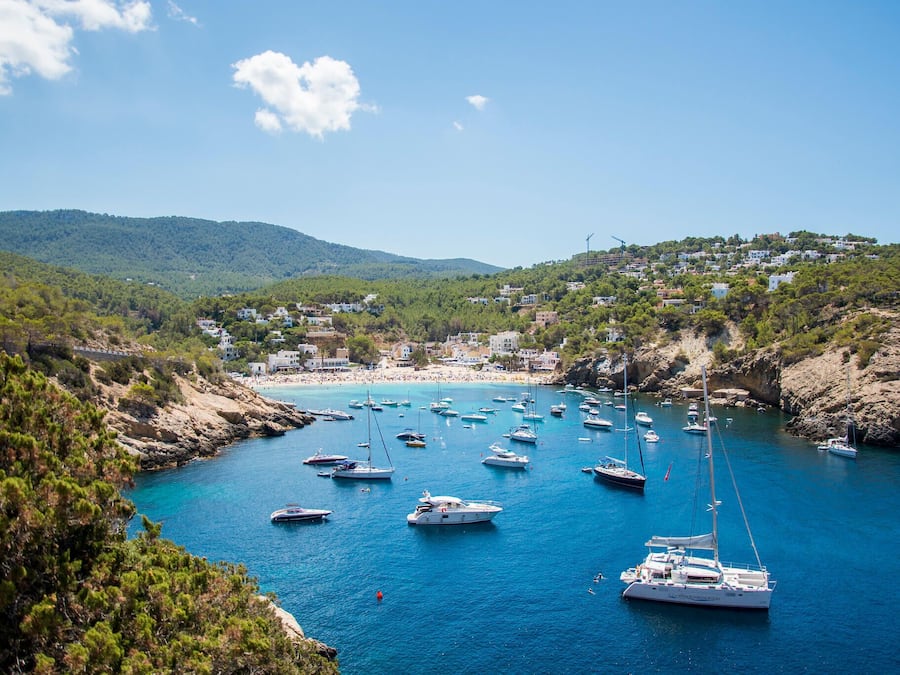 Nær stranden, hvit sand, solsenger og parasoller