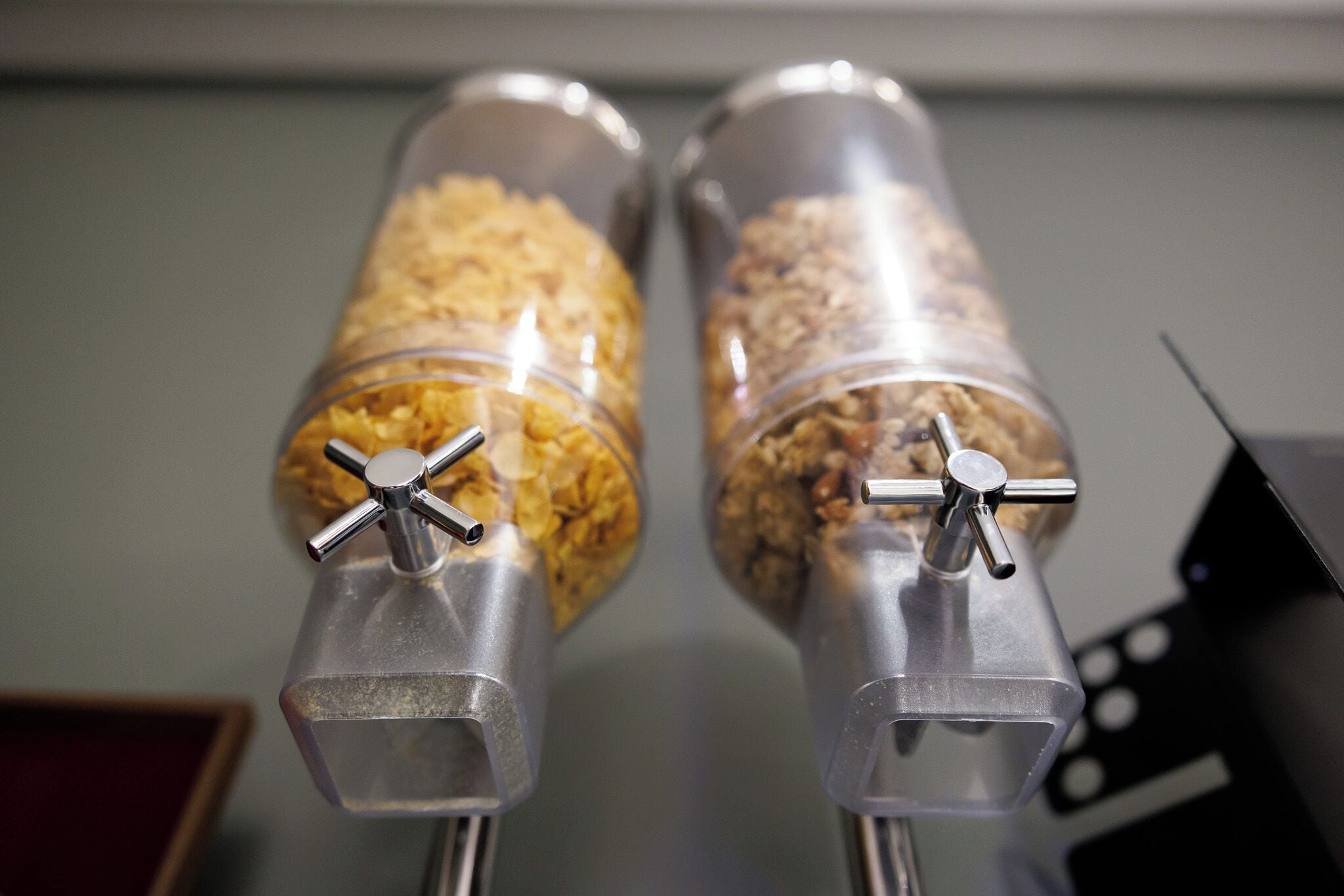 Two transparent containers with metal handles, likely for dispensing food or beverages.