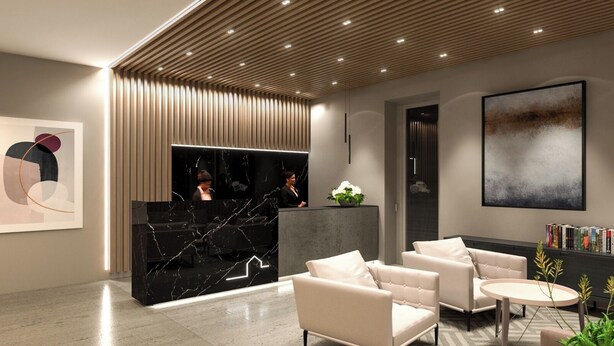 A modern reception area with a marble reception desk, seating area with sofas, and a large abstract painting on the wall. - Casa San Giuseppe (Rome)