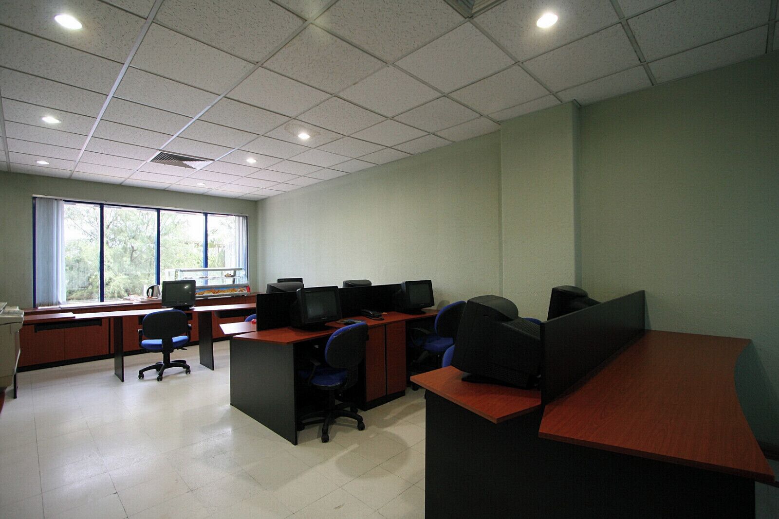A computer lab with multiple workstations, each equipped with a monitor and keyboard.