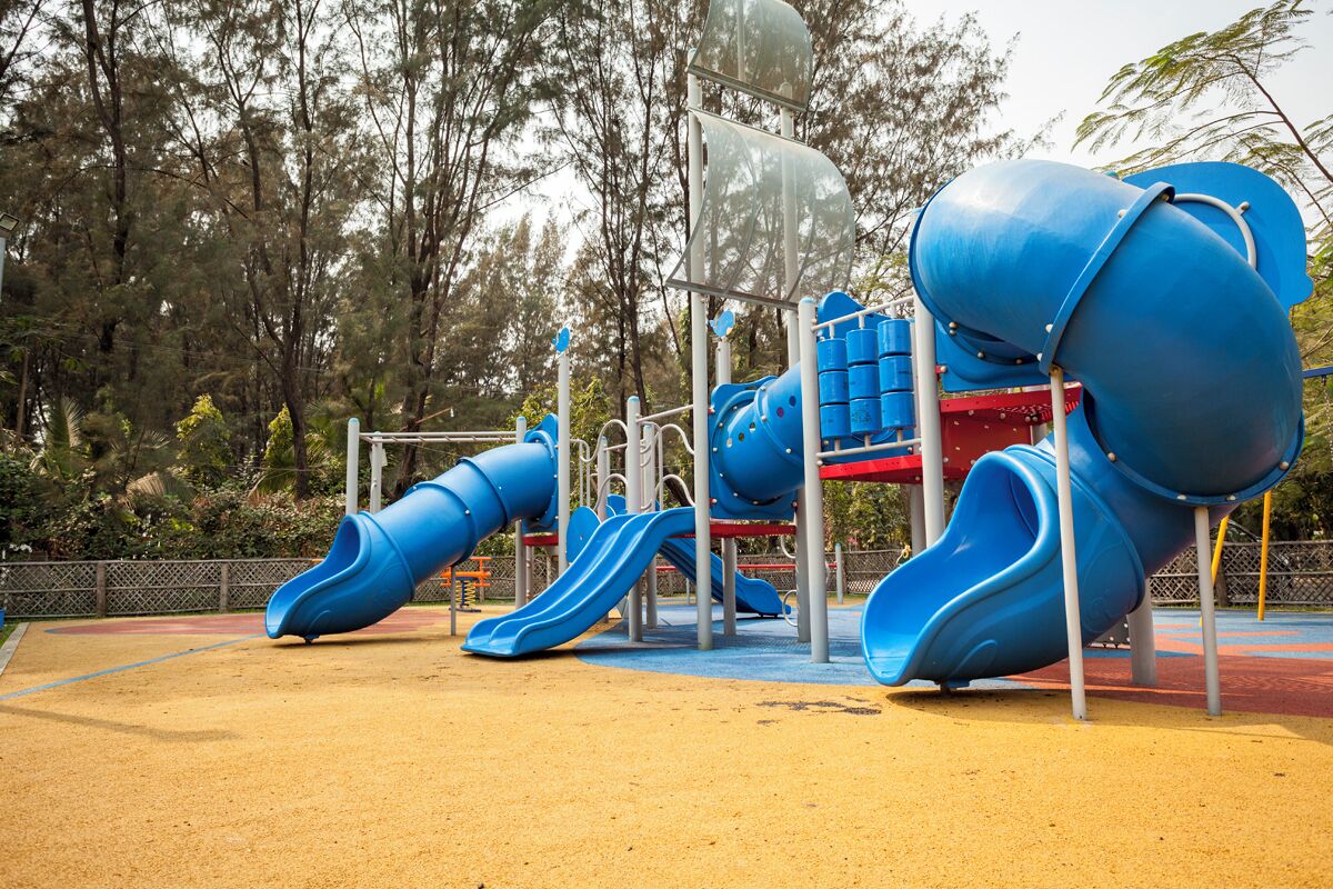 A playground with multiple slides and climbing structures.