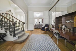 A spacious living area with a staircase, a dining area, and a kitchen.