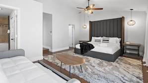 A bedroom with a bed, a ceiling fan, a bedside table, and a nightstand. - The Scott With Heated Pool by Homeslice Stays (Scottsdale)
