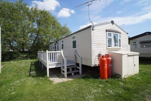 Enjoy a peaceful retreat with a front deck and attached garage, perfect for a self-sufficient stay.