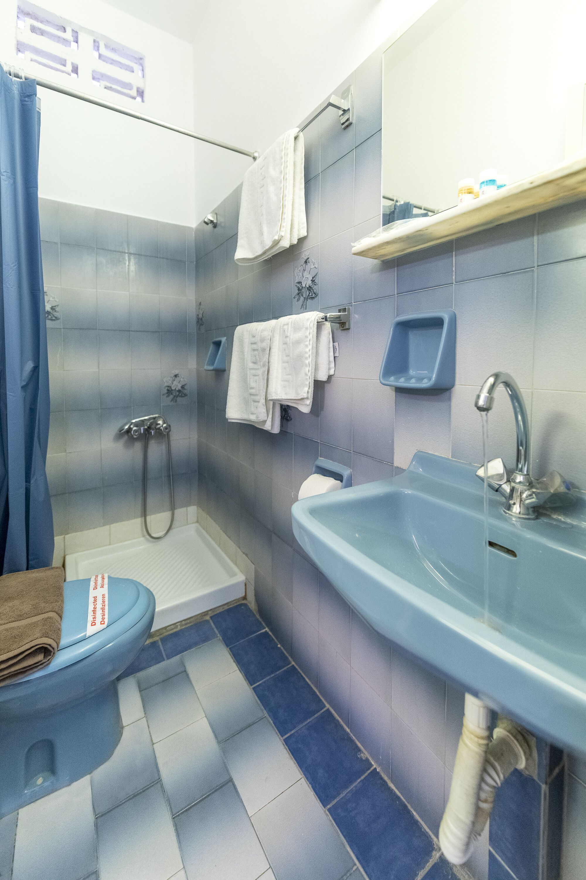 standard twin room | bathroom | shower, hair dryer, towels, soap