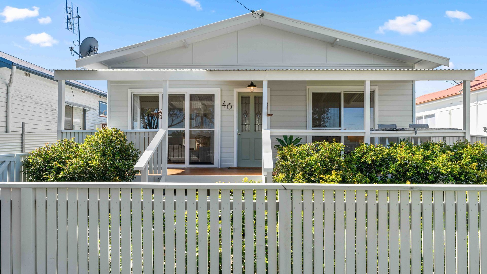 A single-story house with a covered porch, a front door, and a visible number '46'.