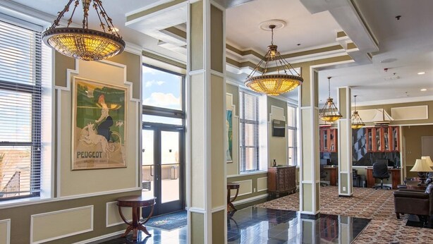 A spacious lobby with high ceilings, large windows, and a polished floor. - Brigantine Beach - 1BR/1BA - Oceanfront property! (Brigantine)