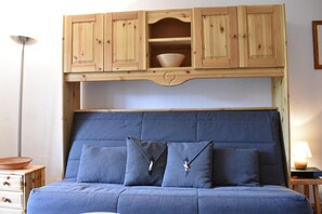 Restful retreat with a large bed and a convenient cabinet above.
