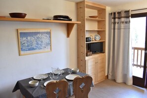 Enjoy meals in this dining area with a table for four, a framed map, and a TV.