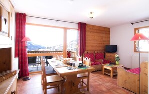 Enjoy a meal for two at the dining table, relax on the sofa, and take in the breathtaking mountain views.