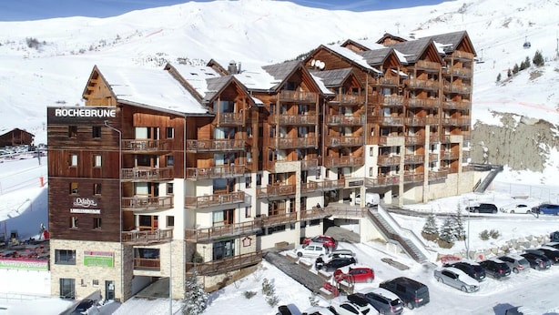A multi-story wooden building with balconies, labeled "ROCHEBRUNE," and a ski lift in the background. - Ski-in/ski-out & foot of the slopes, swimming pool, balcony, tv, 40-45m², Orcières Merlette 1850 (Orcières)