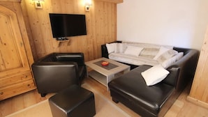 A cozy living room with a sofa, two armchairs, and a coffee table.