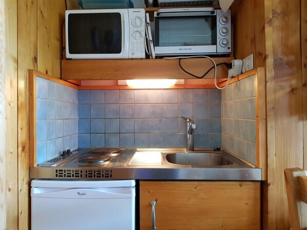 Enjoy cooking in this well-equipped kitchen with a gas stove, double sink, and convenient microwaves.